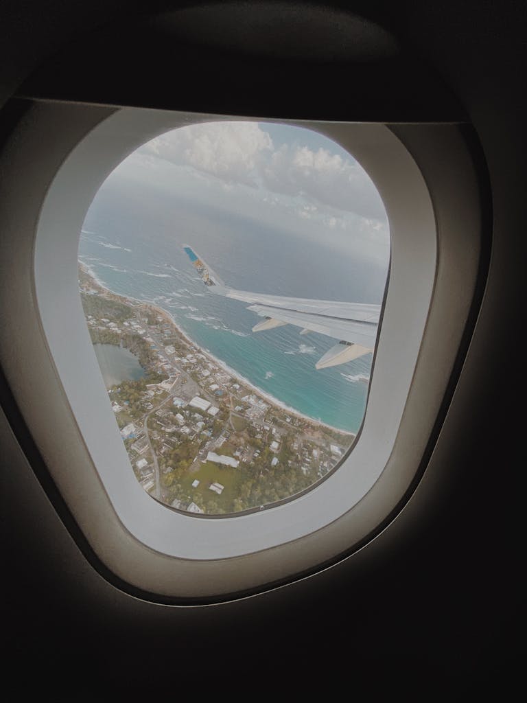 Captivating aerial view from airplane window showing San Juan's stunning coastline.